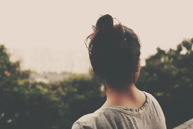 Why Japanese People Look Young Until They Suddenly Don't Japanese woman walking through a quiet neighbourhood street in morning light