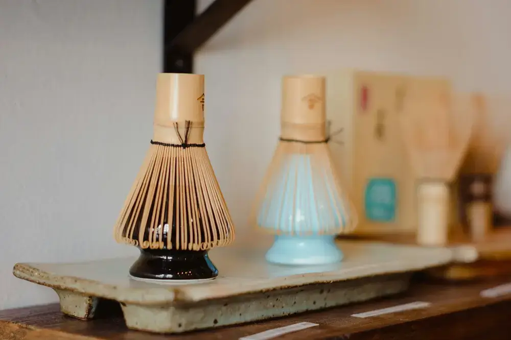 What I Learned Before Making Matcha at Home Bamboo tea whisk (chasen) resting on a wooden shelf