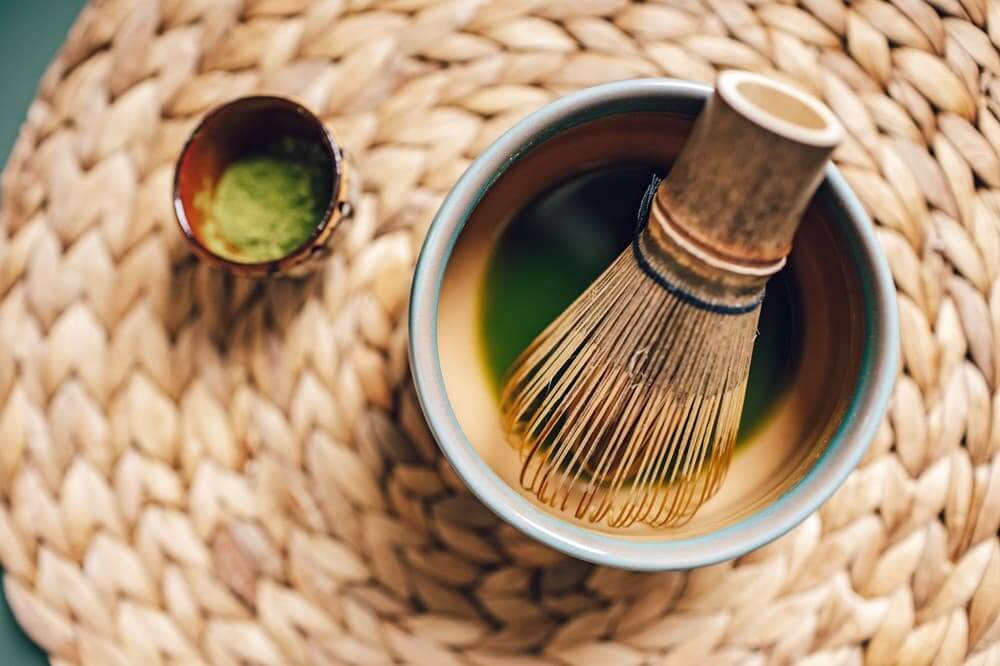 What I Learned Before Making Matcha at Home Bamboo matcha tea whisk in a ceramic bowl