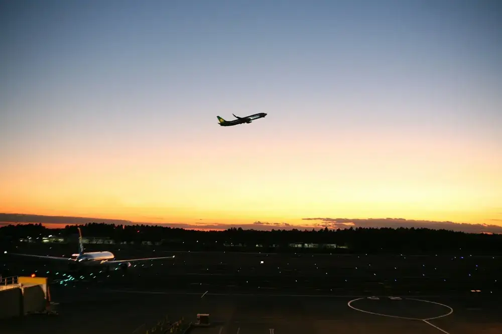 The Best Hotels in Tokyo for Families of Four (Without Compromising on Beds) Airport shuttle bus outside a hotel entrance at dusk