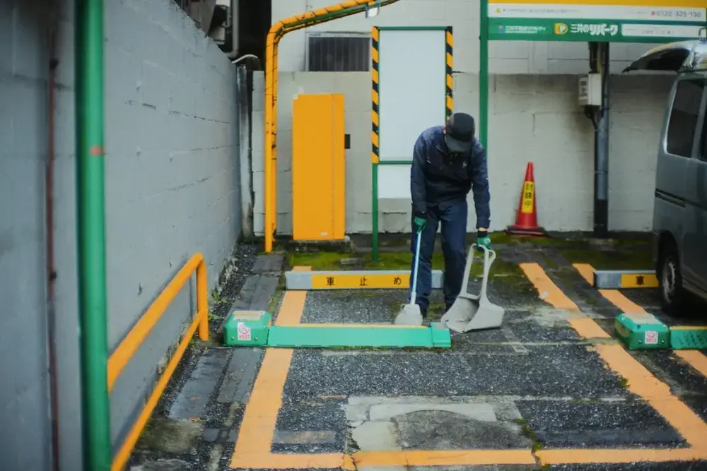 The Most Expensive Thing Japan Gives You for Free A man cleaning a public space carefully in Japan