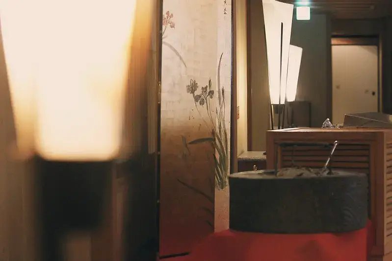 The Onsen Paradox: Why Japanese People Aren’t Embarrassed to Bathe Naked Together Traditional Japanese onsen interior with warm lighting and wooden accents