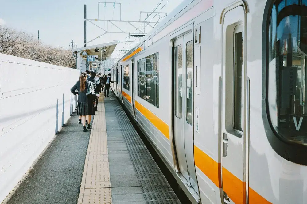 The Most Expensive Thing Japan Gives You for Free Commuters boarding a train in an orderly line in Japan