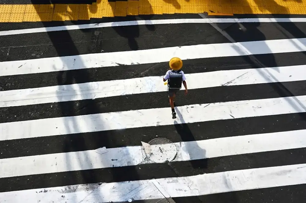 Why Japanese Children Walk to School Alone Young Japanese child in yellow school hat walking alone to school