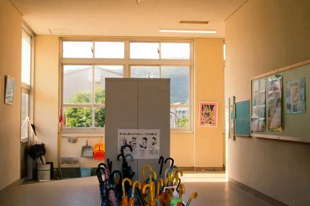 Why Japanese Children Walk to School Alone Row of umbrellas stored inside a Japanese school entrance