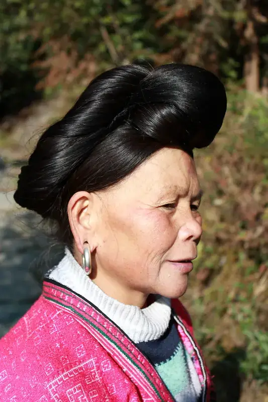 Centuries of Beauty Wisdom Meets Modern Science: Japanese Rice Bran Skincare Red Yao woman with long hair at the Longji Rice Terraces