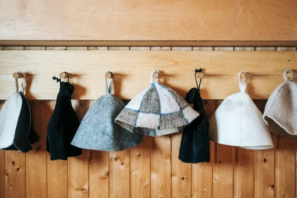 Why Torture Yourself? Why Japan’s Businesspeople Became Obsessed With Sauna Sauna hats hanging on a wooden wall