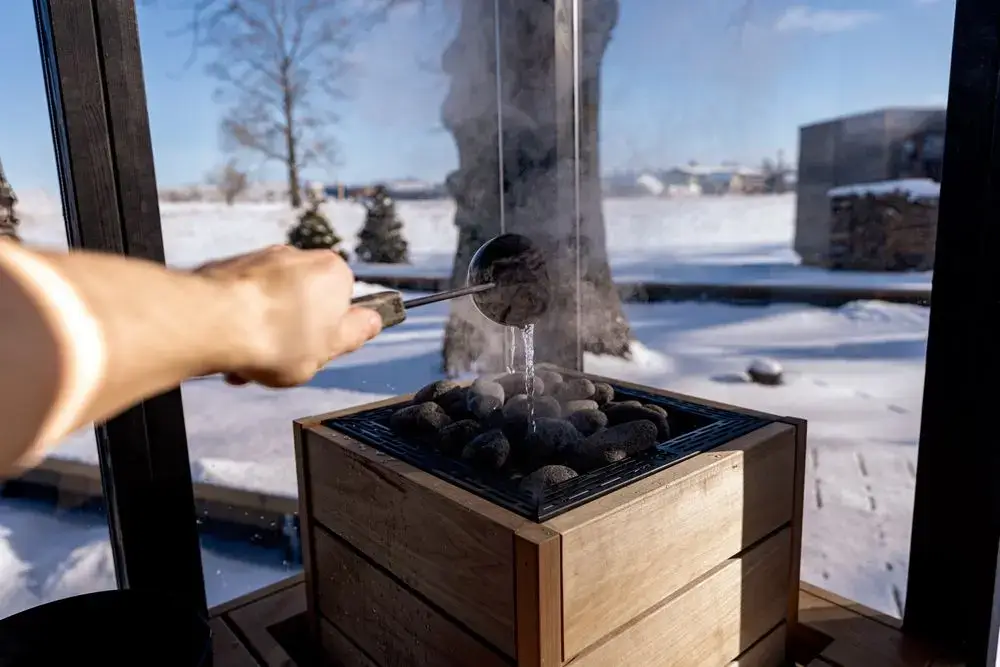 Why Torture Yourself? Why Japan’s Businesspeople Became Obsessed With Sauna Steam rising from sauna stones as water is poured in a snowy Nordic setting