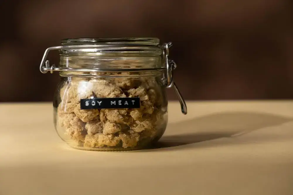 Why Soy Keeps Showing Up in Today’s Biggest Food and Health Trends Soy-based plant meat in a glass jar as an example of a processed soy food