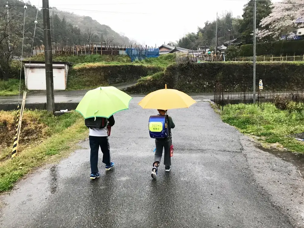 Why Japanese Children Walk to School Alone Young Japanese children walking to school together in the rain
