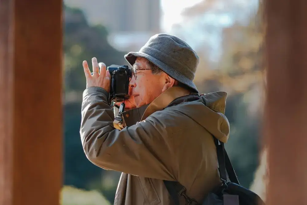 How Japan Thinks About Aging: Purpose, Roles, and the Meaning of Growing Older Older Japanese man taking a photograph outdoors