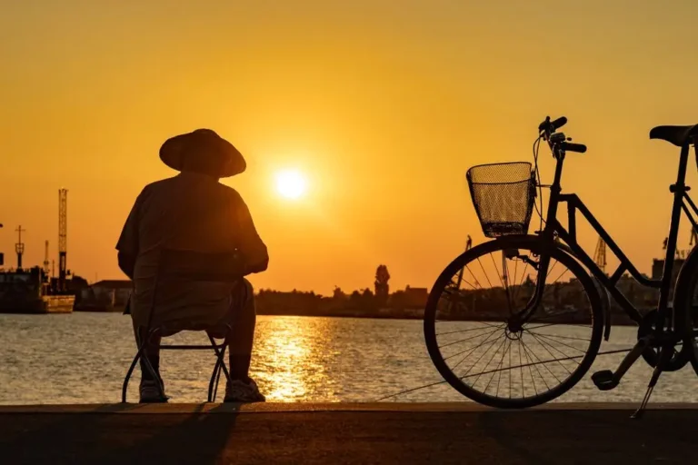 man sitting by the water